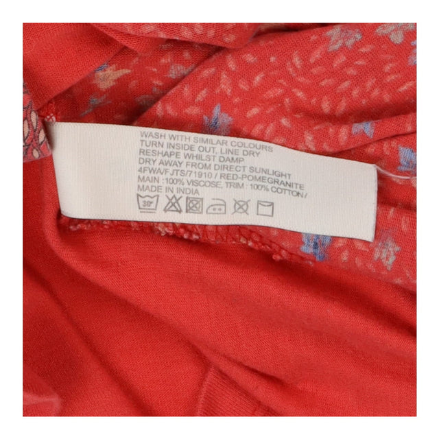 Coral red floral print long sleeve top with pocket
