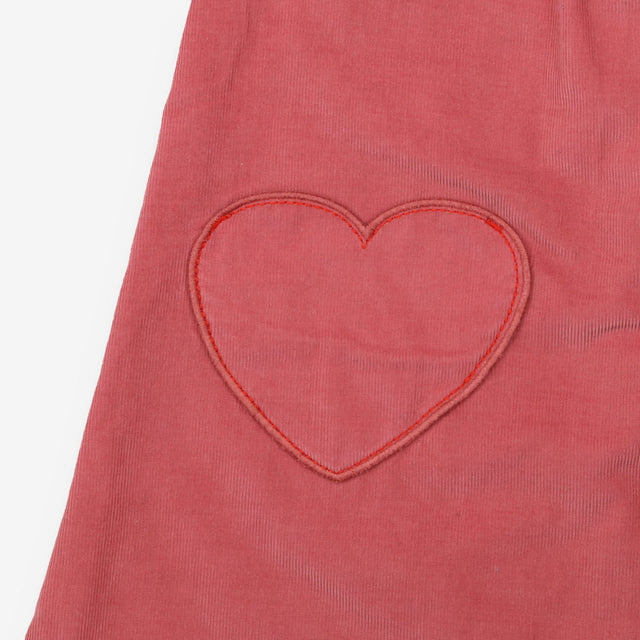 Pink cord pinafore with heart pockets