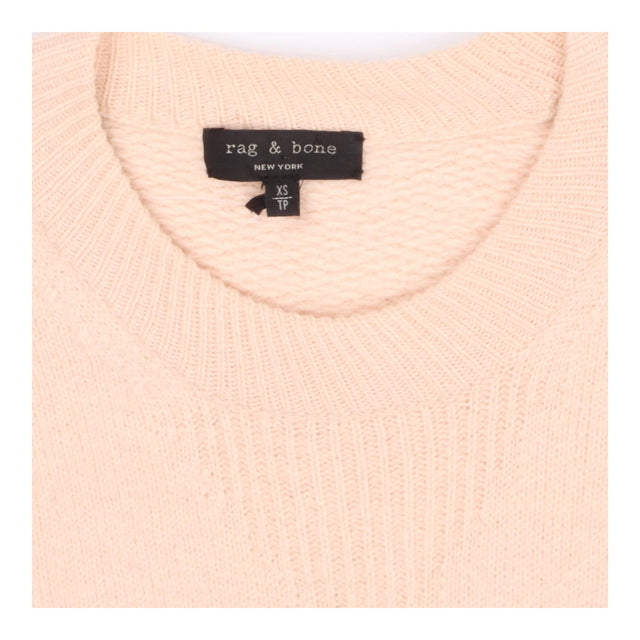 Pink knit crew neck sweater with side button deta