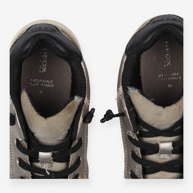 Grey trainers, black laces