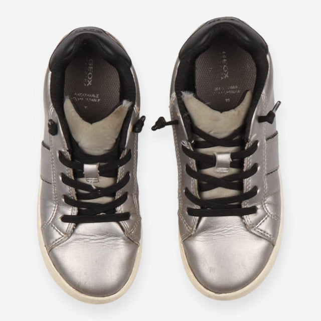 Grey trainers, black laces