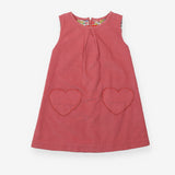 Pink cord pinafore with heart pockets