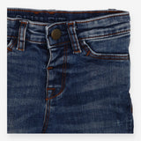 Jeans orange stitching worn leg effect