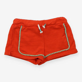 Orange jersey shorts with green pompom edging