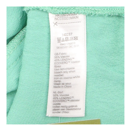 Green Sleeveless Ruffle Front Blouse