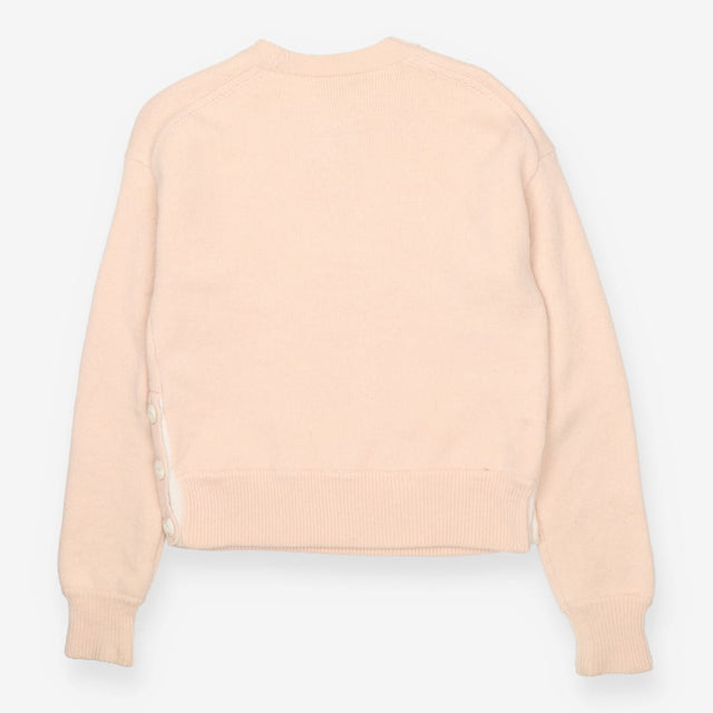 Pink knit crew neck sweater with side button deta