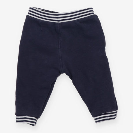 Navy joggers with red buttons
