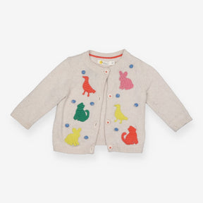 Beige knit animal cardigan with blue pom poms