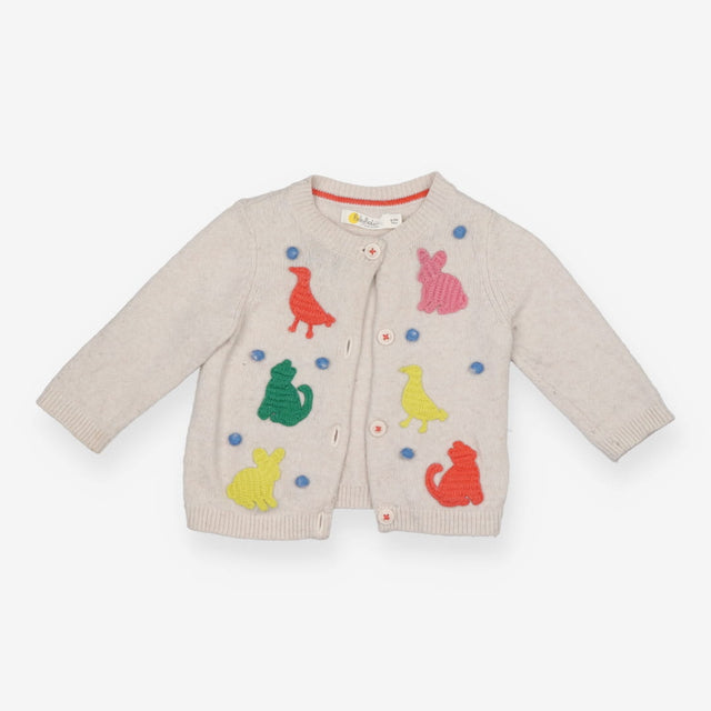 Beige knit animal cardigan with blue pom poms