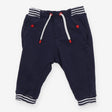 Navy joggers with red buttons