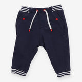 Navy joggers with red buttons