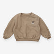 Beige tracksuit skateboarding dog