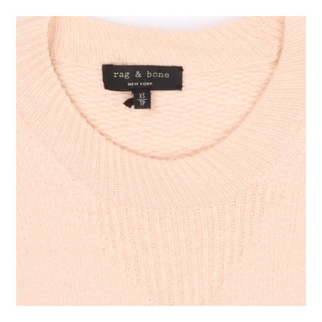 Pink knit crew neck sweater with side button deta