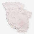 3 tiny baby white bodysuits