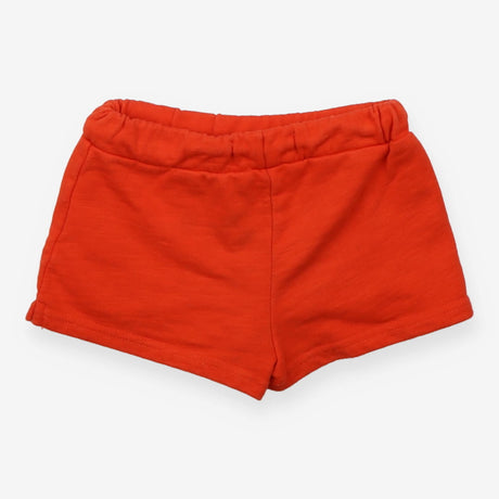 Orange jersey shorts with green pompom edging